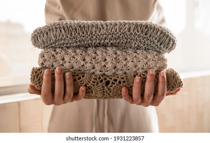Hand holding a stack of sustainable cloths in tracksuit, homemade and Eco friendly fabric - Shutterstock ID 1931223857