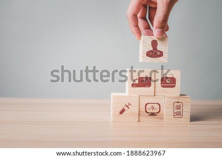 Hand holding stack woods block healthcare and medical icon, Medical equipment are readily available for viewing and and treatment with advanced equipment technology and high safety.