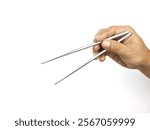 Hand holding stainless steel chopsticks on white background