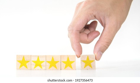 hand holding star on wood, concept of customer service, review, testimonial