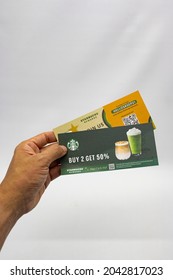 Hand Holding Starbucks Cafe 50% Discount Voucher. Jakarta 17 September 2021.