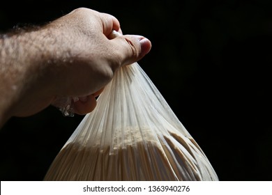 A Hand Holding A Stash Of Brown Heroin. Drug Bust Concept Image. 