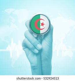 Hand Holding Stethoscope With Algeria Flag.