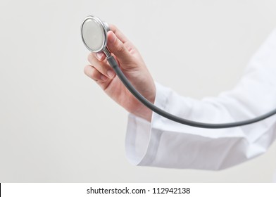 Hand holding stethoscope on clear background