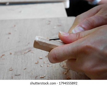 A Hand Holding A Stick Of Wood And Craving 