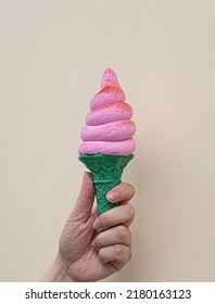 Hand Holding Strawberry Ice Cream Cone