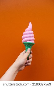 Hand Holding Strawberry Ice Cream Cone