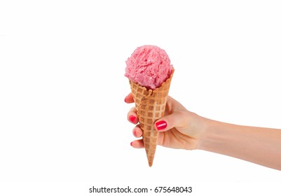 Hand holding strawberry ice cream cone on white background.  Strawberry ice cream in wafer cup. 