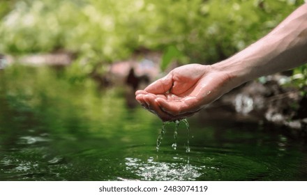 hand is holding a stream of water. Concept of calm and tranquility, as if the person is simply enjoying the moment of being in the water - Powered by Shutterstock