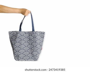 Hand Holding a Stylish Reusable Shopping Tote Bag with Decorative Pattern - Ideal for Eco-friendly Grocery Shopping and Daily Use - Powered by Shutterstock