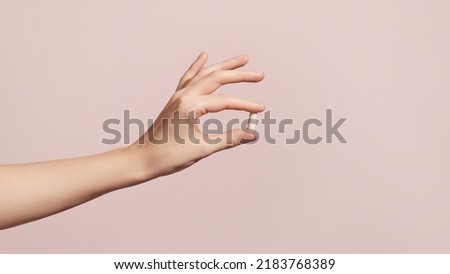 Hand holding the supplements on pink background. High quality photo