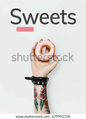 Hand holding sweet dessert donut pastry