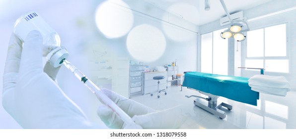 Hand holding syringe and medicine vial prepare for injection in operating room background with blue tone - Powered by Shutterstock