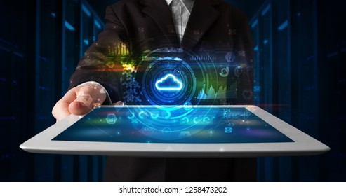 Hand holding tablet with cloud technology and dark concept - Shutterstock ID 1258473202