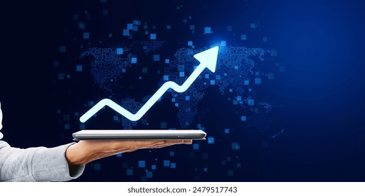 A hand holding a tablet displaying a graph arrow soaring upwards, representing growth, against a digital world map backdrop - Powered by Shutterstock