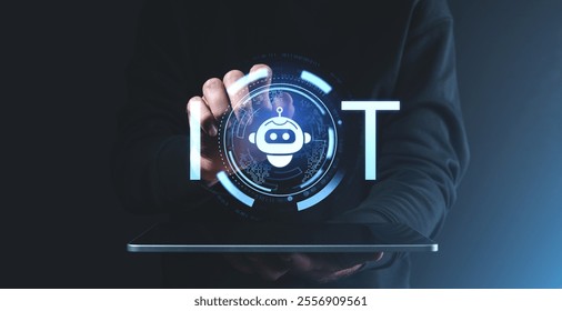 A hand holding a tablet displaying a holographic robot icon with IoT text and futuristic graphics, on a dark background, symbolizing modern technology - Powered by Shutterstock - Get 15% off with code: PIKWIZARD15