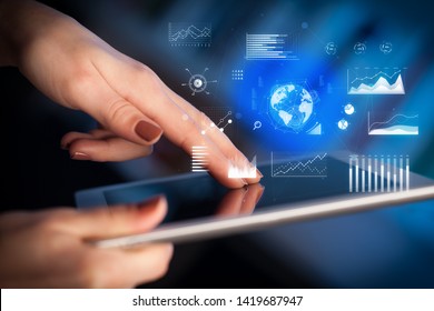Hand holding tablet with global business concept