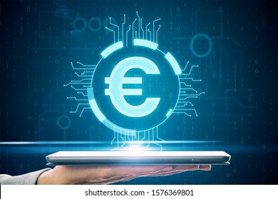 Hand holding tablet with glowing blue euro icon interface hud. Technology and money concept. - Powered by Shutterstock - Get 15% off with code: PIKWIZARD15