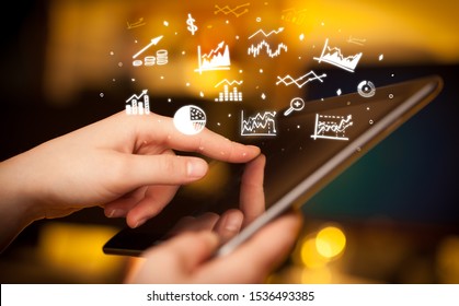 Hand holding tablet with online business report concept