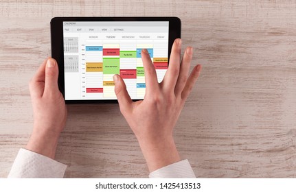 Hand Holding Tablet With Timetable And Calendar Concept