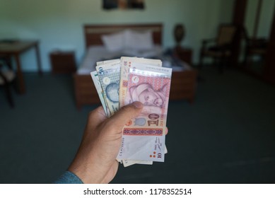Hand Holding Tajikistani Somoni Bills Stacks