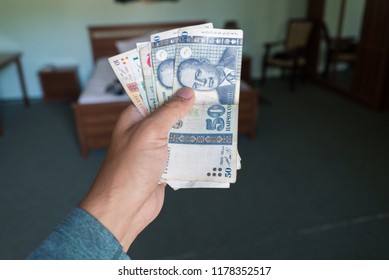 Hand Holding Tajikistani Somoni Bills Stacks
