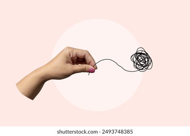 A hand holding a tangled piece of string. The image is meant to represent the idea of chaos and confusion