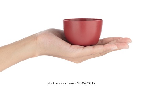 Hand Holding Tea Cup Isolated On A White Background