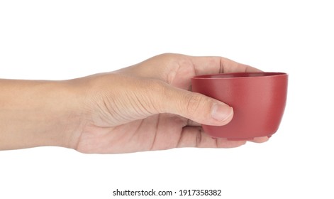 Hand Holding Tea Cup Isolated On A White Background