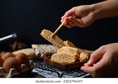 Hand holding Tempeh with bamboo chopsticks Vegan appetizers, traditional Indonesian soy product - Powered by Shutterstock