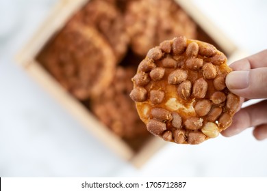 Hand Holding Thai Fried Peanut Cookies For Asian Dessert, Food And Eating Concept