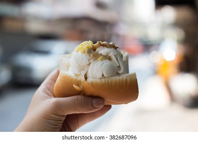 Hand Holding Thai Style Coconut Ice Cream In A Bread Sandwich