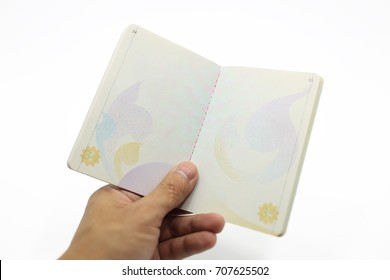 Hand Holding Thailand Passport Open Against White Background