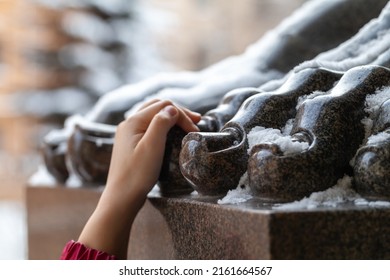 Hand holding a toe of the Atlas statue, tourist omen to make a wish. Classic architecture of Saint-Petersburg, Russia - Shutterstock ID 2161664567