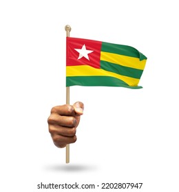 Hand holding Togolese national flag isolated on white background
