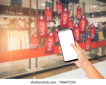 Hand Holding And Touch Screen Smartphone On Shopping Mall Background Blurred