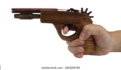 Hand Holding Toy Wooden Gun Isolated On White Background.