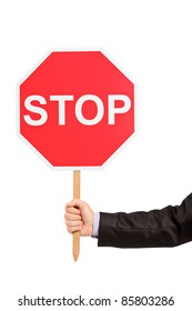 A hand holding a traffic sign stop isolated against white background