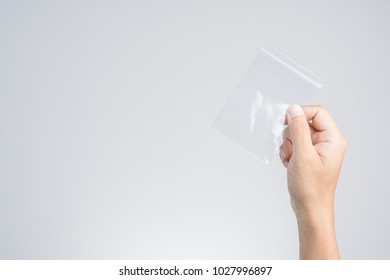 Hand Holding Transparent Plastic Zip Lock Or Zipper Bag