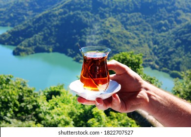 Hand Holding A Turkish Tea Glass At Nature