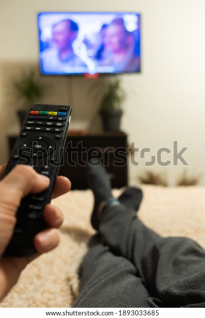 hand holding tv remote\
close-up