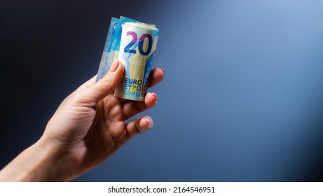 Hand holding twenty euro banknotes. European currency in cash and money as symbol of success and wealth - Shutterstock ID 2164546951