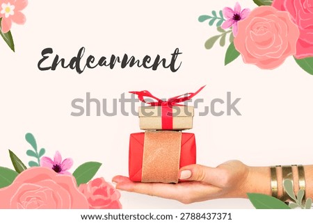A hand holding two gift boxes with floral decorations and 'Endearment' text. Pink and red flowers frame the image, creating a festive feel.