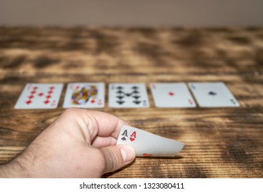 A hand holding two shots, a winning combination in playing cards - Shutterstock ID 1323080411