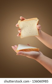 Hand Holding Two Slices Of Bread