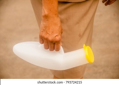 Hand Holding The Urinal Male Portable On White Background