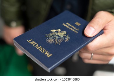 Hand Holding US Passport For The Immigration