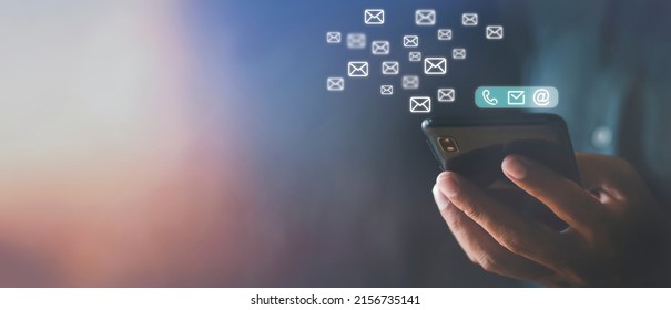 Hand Holding Using Mobile Phone With Email Icon On Screen. Business Communication Technology Concept. Hand Man Holds Phone Sent And Receive Email From Internet. Copy Space Banner