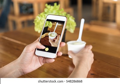 Hand Holding Using Mobile Phone.girl Using Smart Phone.take A Photo