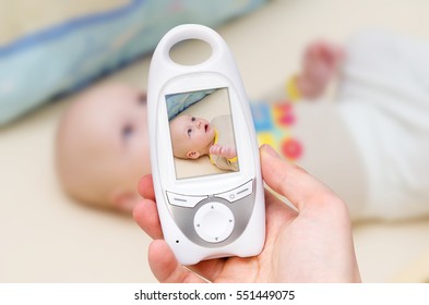 Hand Holding Video Baby Monitor For Security Of The Baby